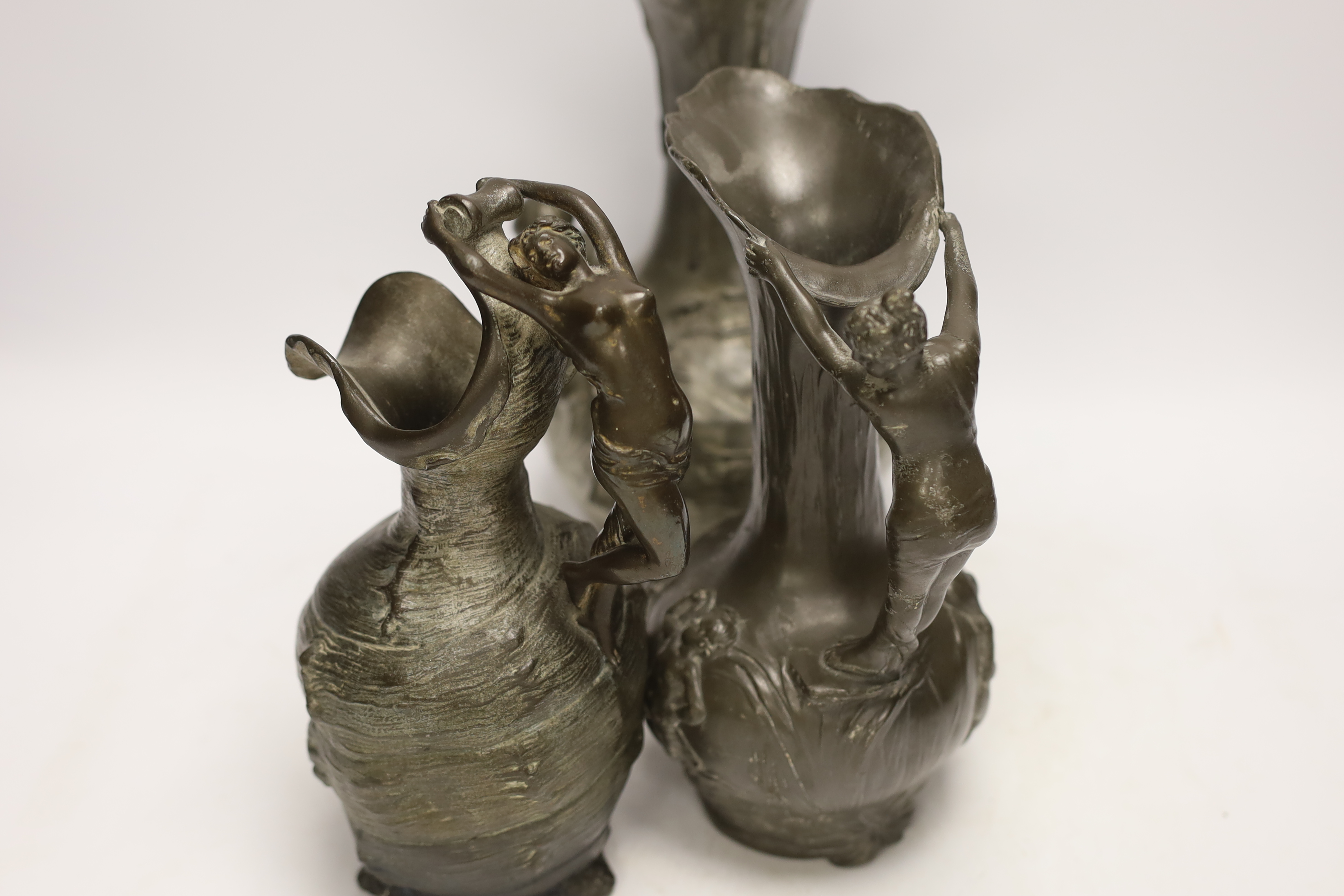 An Art Nouveau Kayserzinn pewter vase and two similar Etan Garanti pewter ewers, signed ‘H. Huppe’ and ‘Petiz’, tallest 27cm